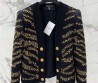 Женский костюм Balmain 2023 черный с золотым украшением