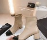 Женские кожаные сапоги Chanel 2024 бежевые с черным носком
