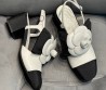 Женские комбинированные туфли Chanel 2024 белые с черным с цветком