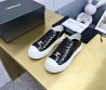Женские кожаные кеды Chanel 2024 черные лакированные с золотистым значком