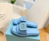 Женские шлепки Prada голубые с эффектом рафии 2024