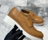Женские кожаные лоферы Prada коричневые с логотипом на толстой подошве 2024