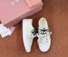 Женские текстильные кеды Miu Miu светло-желтые с разноцветными шнурками 2025