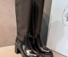 Женские кожаные сапоги Prada черные на каблуке 2025